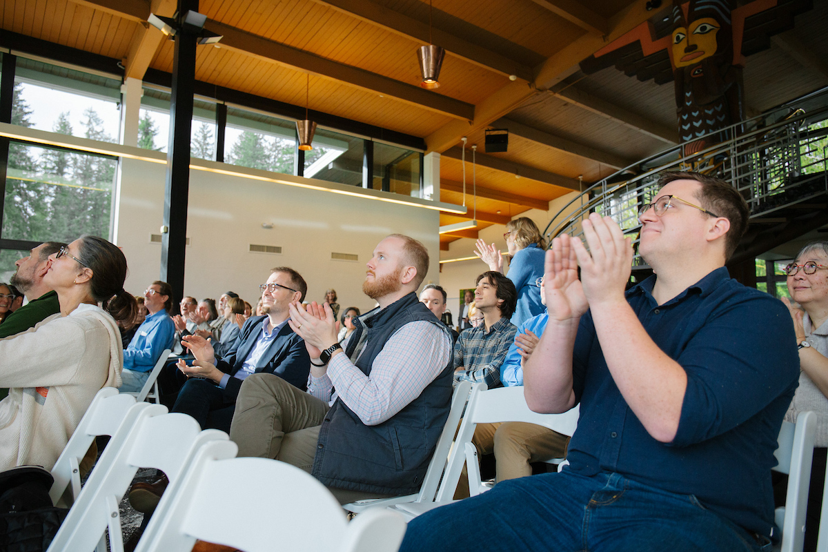 Audience members applaud at an award ceremony