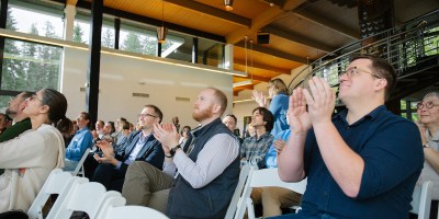 Audience members applaud at an award ceremony