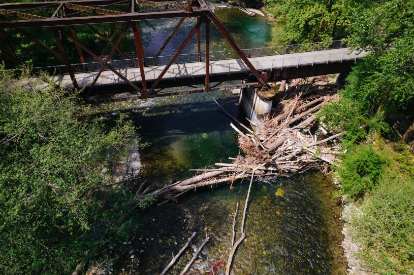 Aerial photo of river with a steel bridge and large woody debris